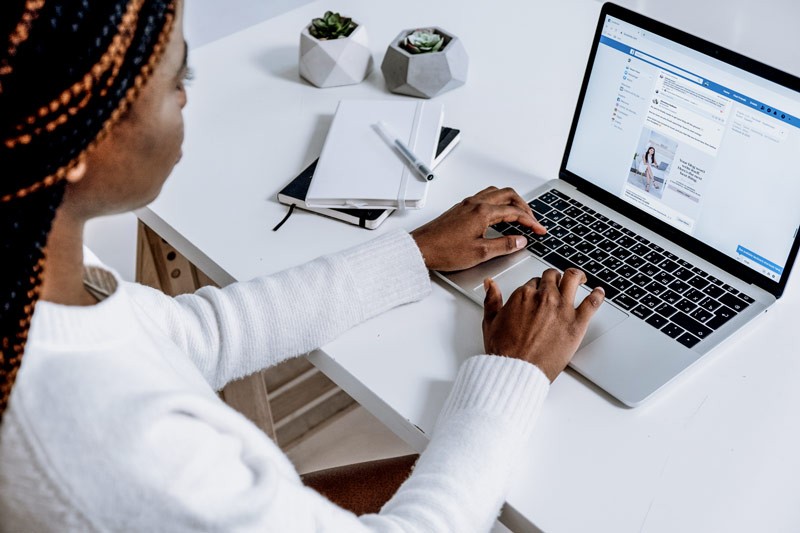 Woman looking at a Facebook ad on her laptop